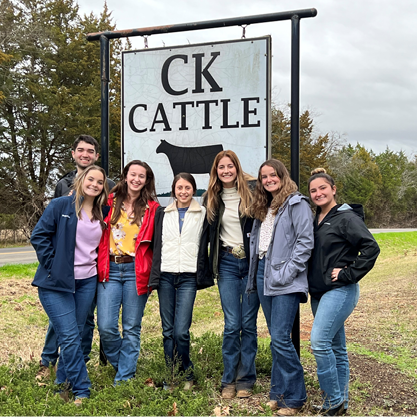 Group of students standing in front of CK Cattle sign