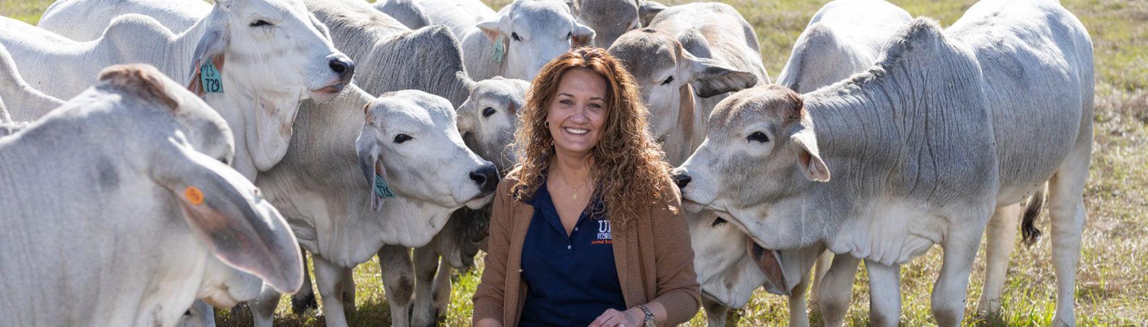 Fernanda Rezende posing with brahman cattle behind her